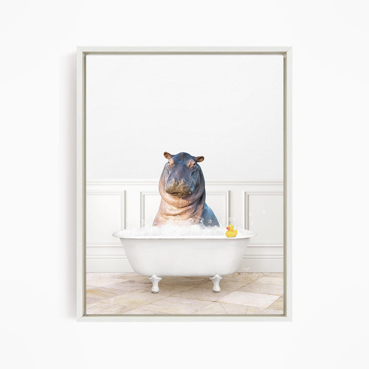 A hippopotamus sitting in a white bathtub filled with water, with a rubber duck floating nearby.