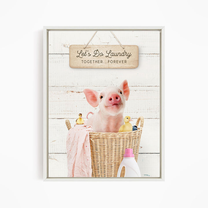 A cute pig sitting in a wicker basket filled with rubber ducks, accompanied by a sign that says "Let's Do Laundry Together Forever".