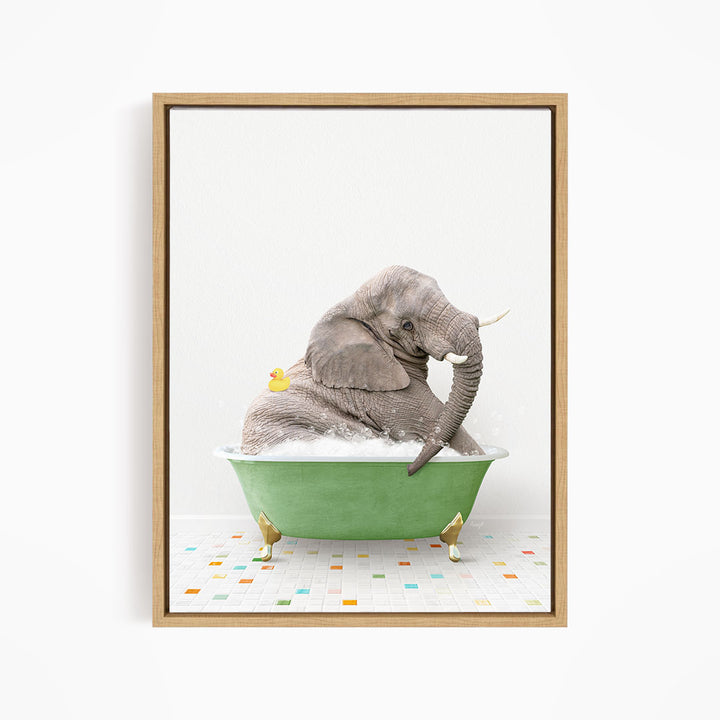 A gray elephant is sitting in a green bathtub, with a yellow duck perched on its back.