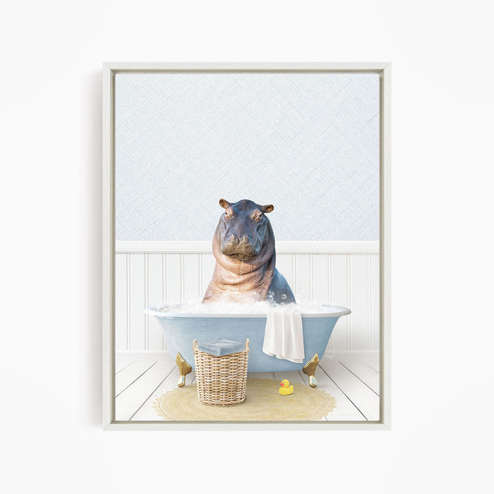 A hippopotamus sitting in a blue bathtub filled with water, surrounded by a yellow rubber duck and a wicker basket.