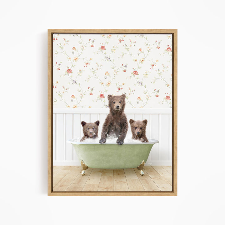A framed image depicting three bears sitting in a green bathtub, with a floral wallpaper in the background.