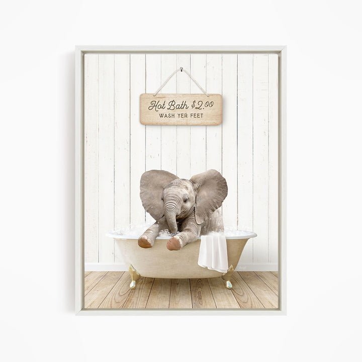 A baby elephant sitting in a bathtub, with a sign above it that reads "Hot Bath $2.00 WASH YER FEET".