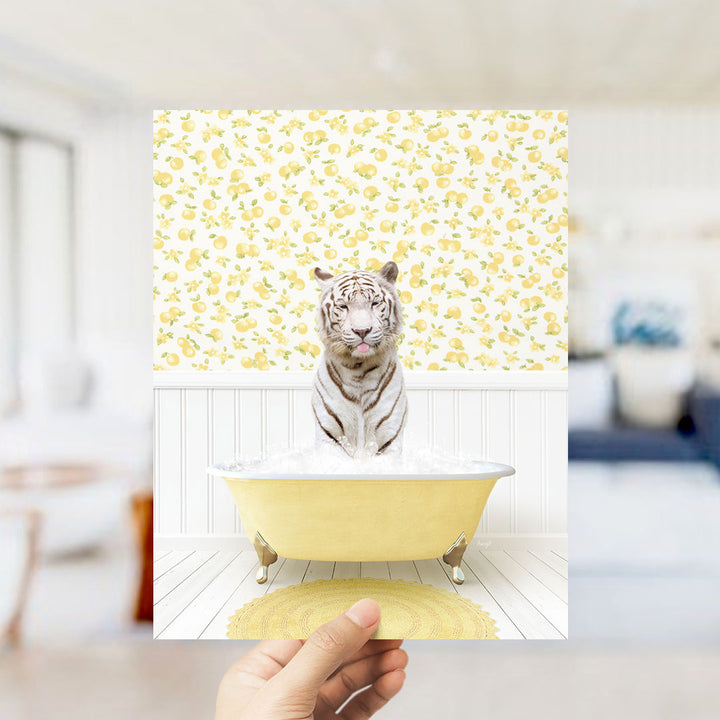 A white tiger is sitting in a yellow bathtub filled with water, surrounded by a yellow and white patterned wall.