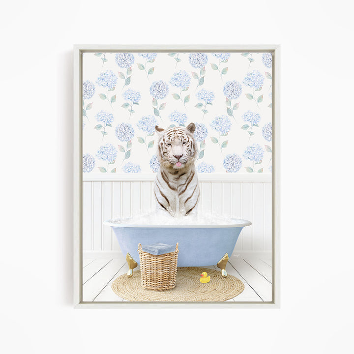 A white tiger is sitting in a blue bathtub filled with water, surrounded by a wicker basket and a yellow rubber duck.