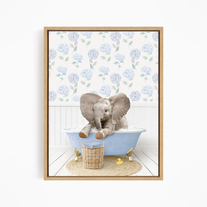 A baby elephant sitting in a blue bathtub, surrounded by a wicker basket and yellow rubber ducks.