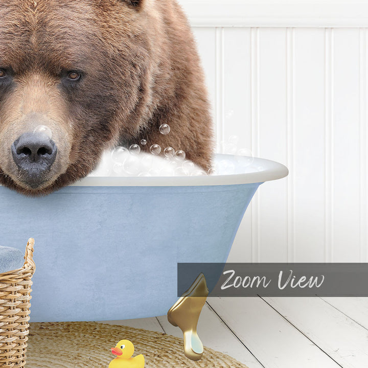 A large brown bear is sitting in a blue tub filled with bubbles, surrounded by a yellow rubber duck and a woven basket.