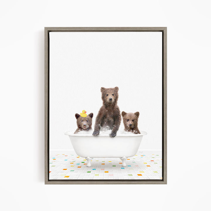 A framed image depicting three bears sitting in a white bathtub filled with water, with a colorful tiled floor beneath them.