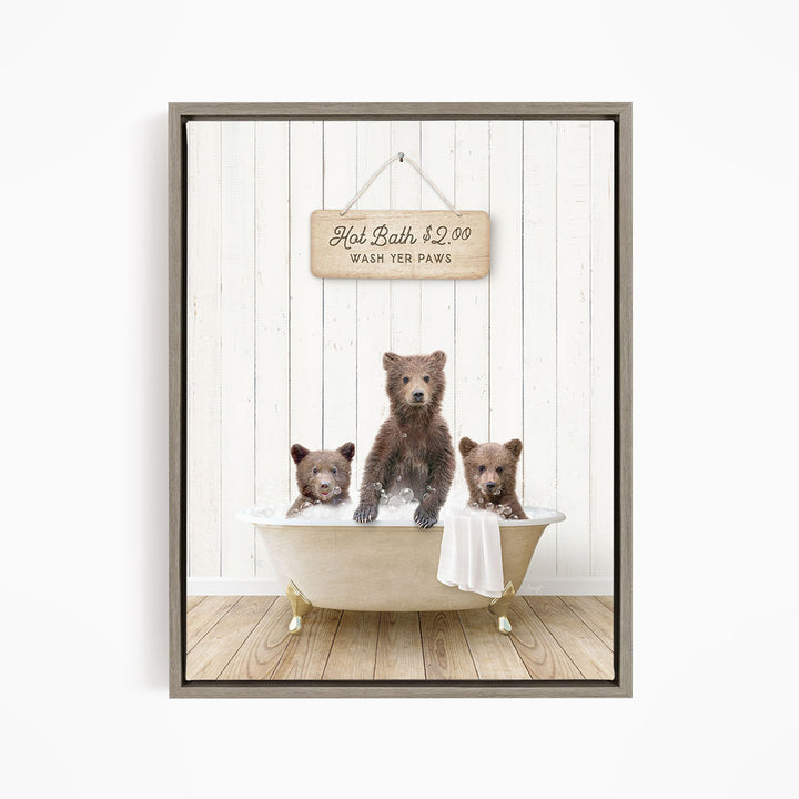A framed image depicting three brown bears sitting in a bathtub, with a sign above them that reads "Hot Bath $2.00 Wash Your Paws".