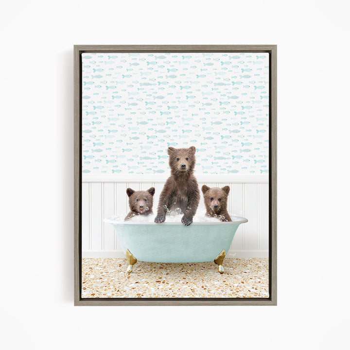 A framed image depicting three bears sitting in a bathtub filled with water, with a patterned wallpaper in the background.
