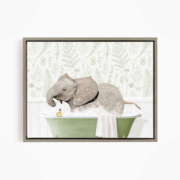 A gray elephant is sitting in a green bathtub filled with water, surrounded by a white wall with a green and white floral pattern.