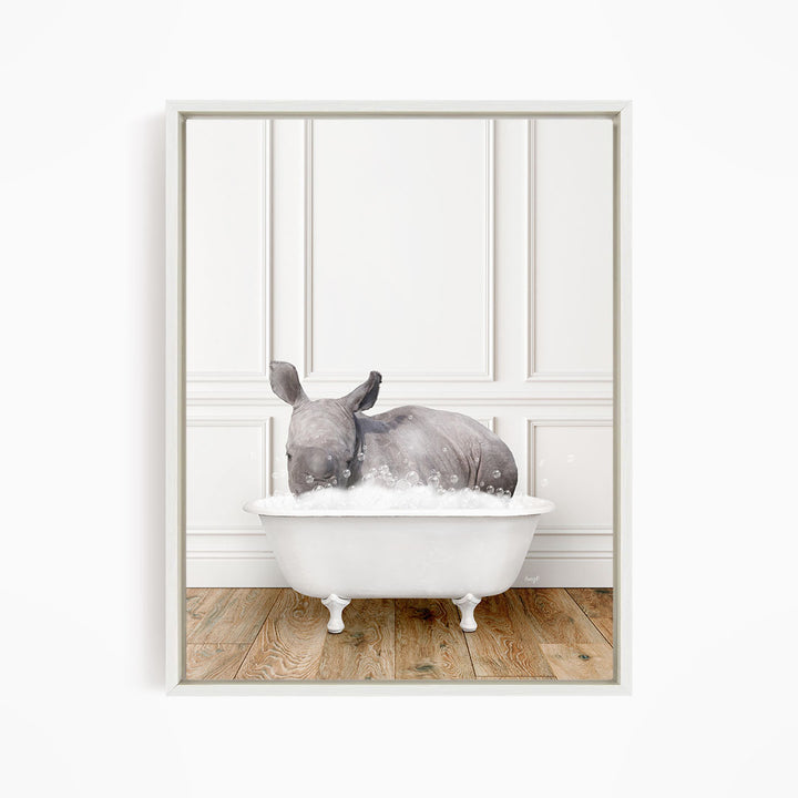 A rhinoceros is sitting in a white bathtub filled with water, creating a whimsical and playful scene.