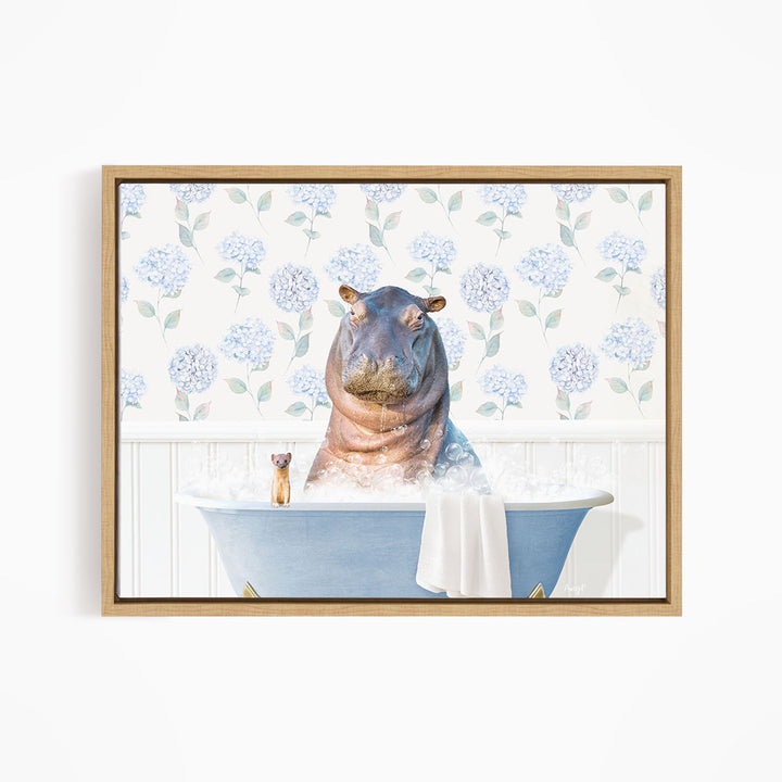 A framed image depicting a hippopotamus sitting in a bathtub, surrounded by a floral patterned wall and a small figurine.