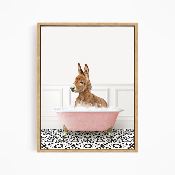 A donkey is sitting in a pink bathtub filled with water, surrounded by a black and white patterned floor.
