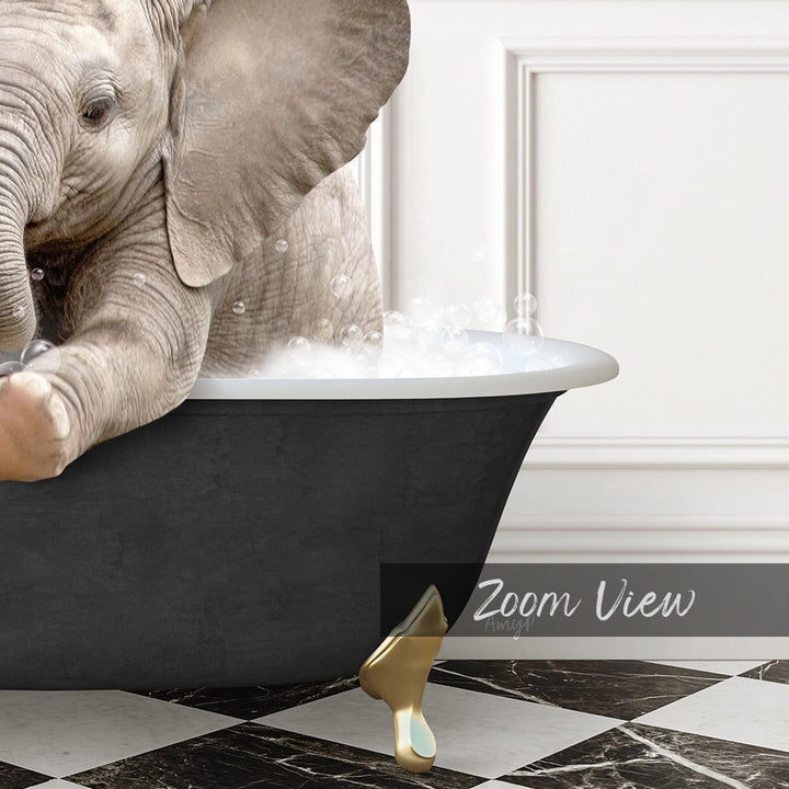 A baby elephant sitting in a bathtub filled with water, surrounded by bubbles.