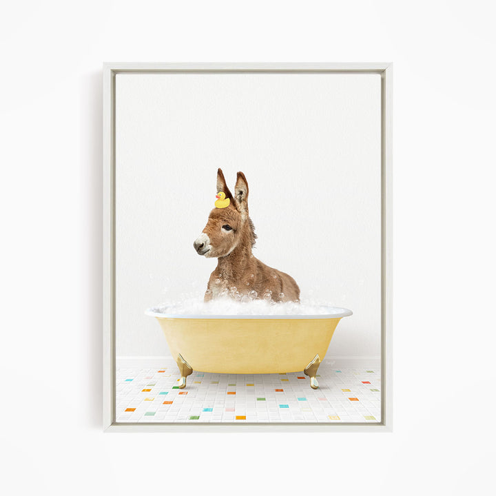 A donkey is sitting in a yellow bathtub filled with bubbles, wearing a yellow hat.