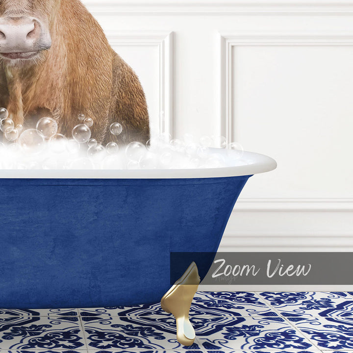 A brown cow is sitting in a blue bathtub filled with bubbles, with a white wall and a patterned tile floor in the background.
