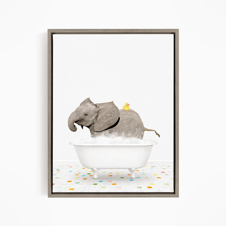 A gray elephant is sitting in a white bathtub, with a yellow rubber duck perched on its back.