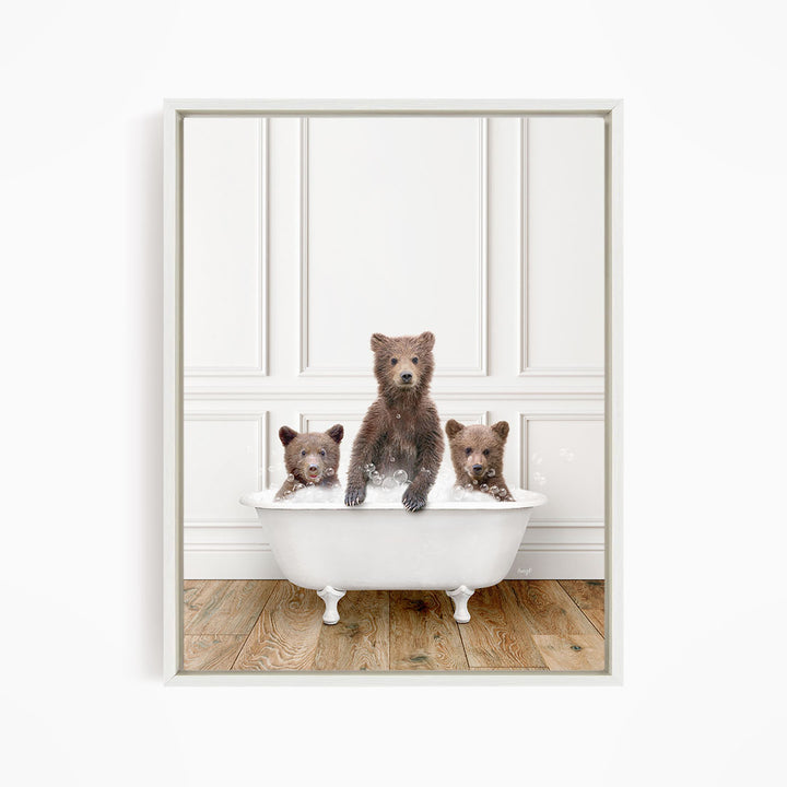 Three adorable brown bears sitting in a white bathtub, enjoying a relaxing bath together.