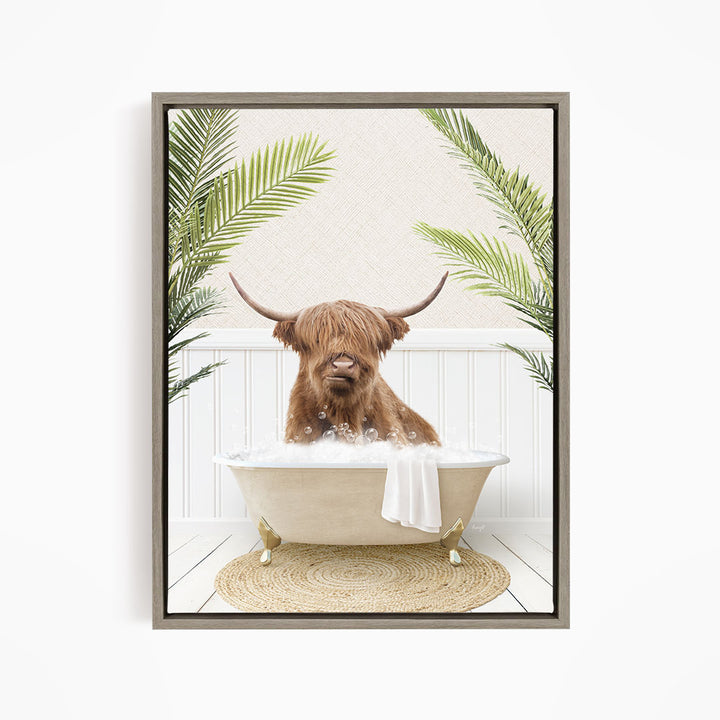 A brown cow with long horns is sitting in a white bathtub filled with bubbles, surrounded by green palm leaves.