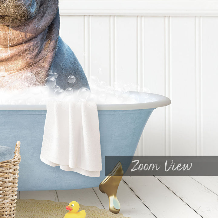 A bathtub filled with bubbles, with a towel hanging over the side and a rubber duck nearby.