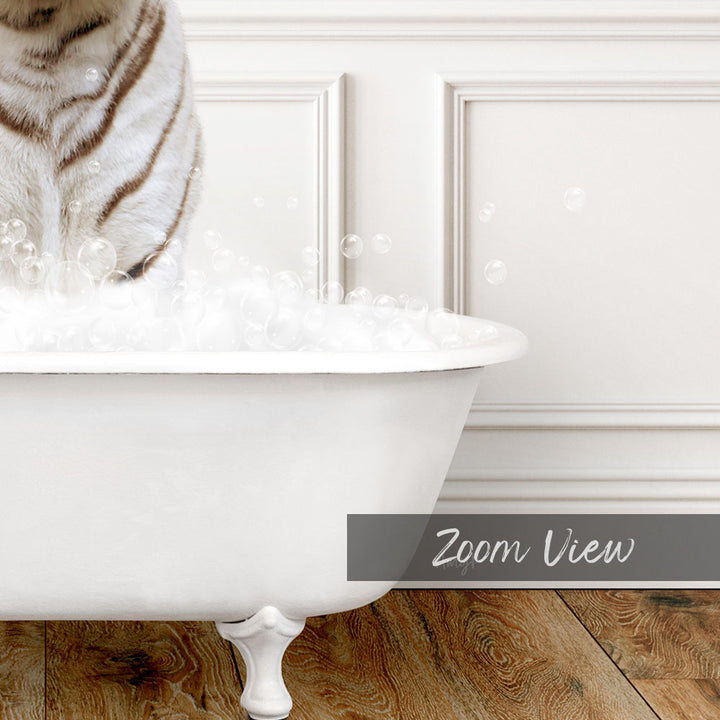 A white cat standing in a bathtub filled with bubbles, with a wooden floor visible in the background.