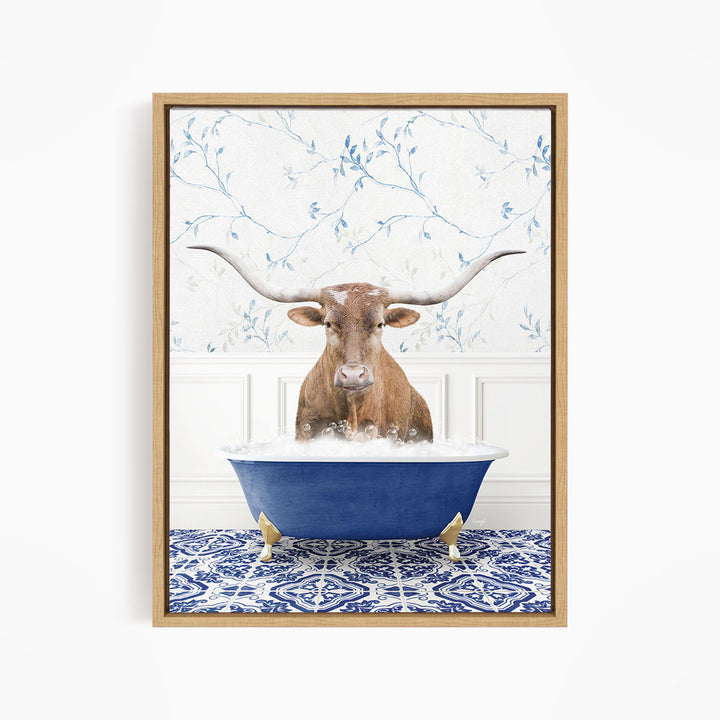 A brown cow with large horns is sitting in a blue bathtub filled with water, surrounded by a blue and white patterned tile floor.