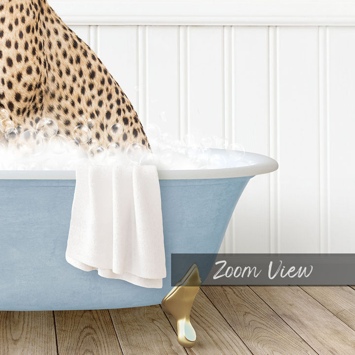 A leopard sitting in a blue bathtub, with a towel draped over its back and a gold bathtub leg visible.