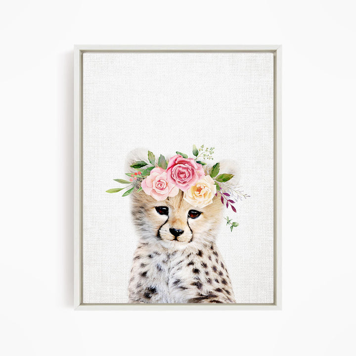A cheetah wearing a floral crown of pink and yellow flowers.