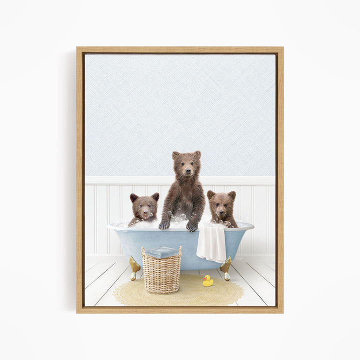 A framed image depicting three bears sitting in a bathtub, with one bear sitting in the center and the other two bears sitting on either side.
