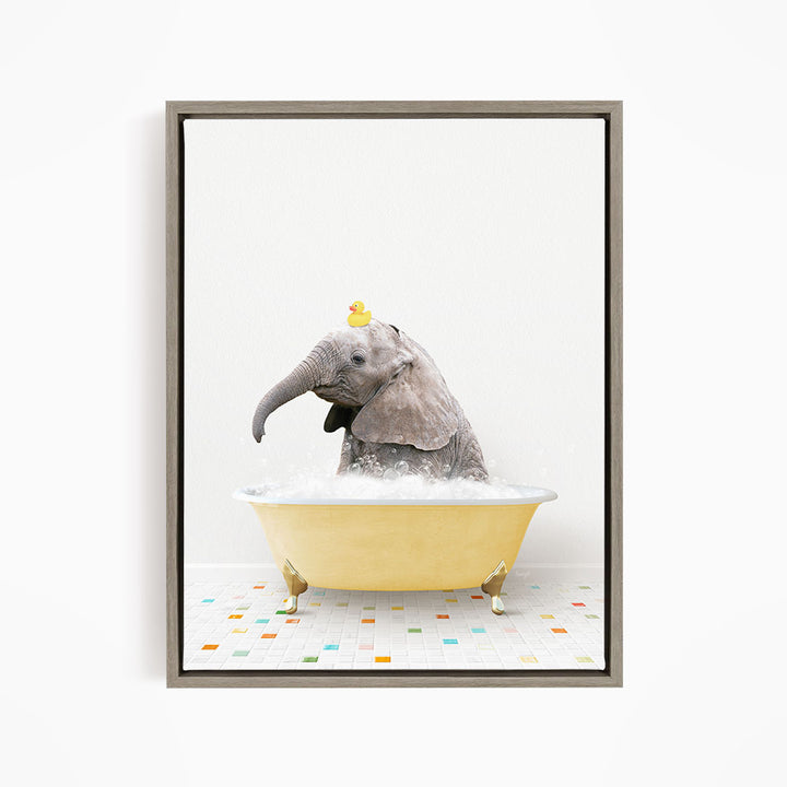 A gray elephant is sitting in a yellow bathtub, with a yellow rubber duck perched on its head.
