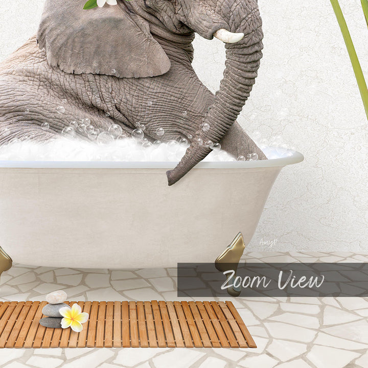 A large gray elephant is sitting in a white bathtub filled with bubbles, surrounded by a wooden mat and a single yellow flower.