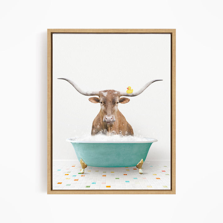 A brown cow with large horns is sitting in a blue tub filled with bubbles, with a yellow rubber duck floating on the water.