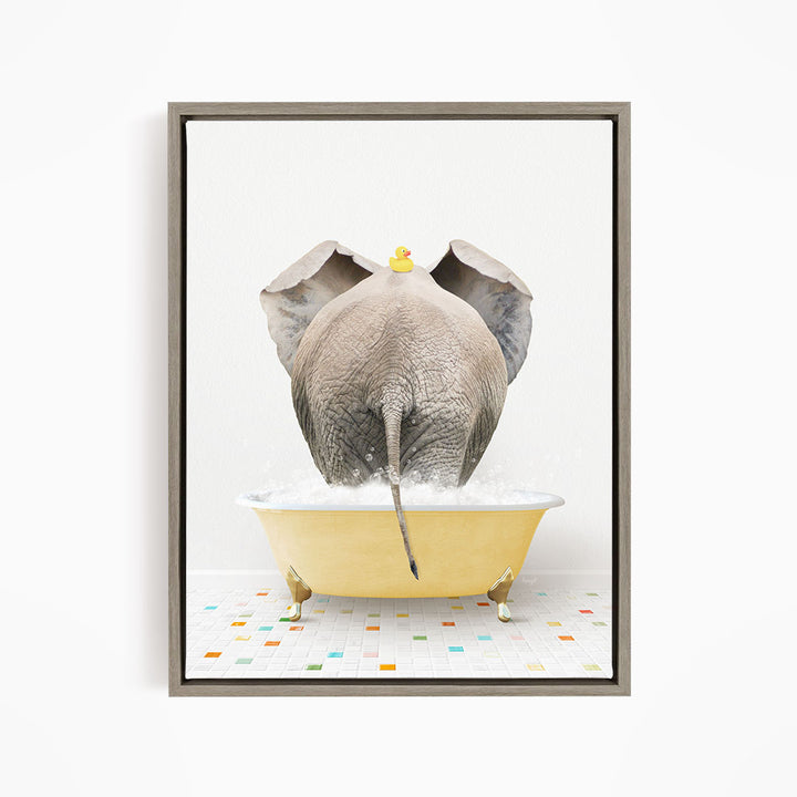 An elephant is taking a bath in a yellow tub, with a rubber duck floating on its head.