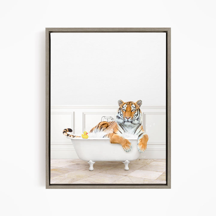 A tiger is sitting in a white bathtub, surrounded by a yellow rubber duck.