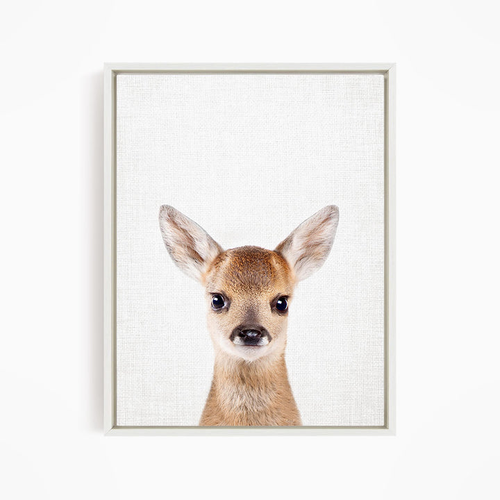 A framed print of a deer's head with large, alert ears and a curious expression.