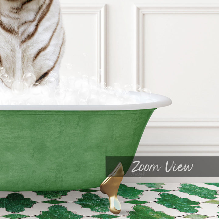 A white and brown striped cat is standing in a green bathtub filled with bubbles, with a gold faucet and a patterned tile floor visible in the image.