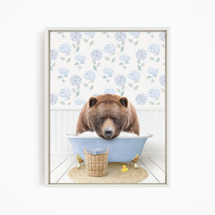 A brown bear is sitting in a blue bathtub filled with water, surrounded by a wicker basket and a yellow rubber duck.