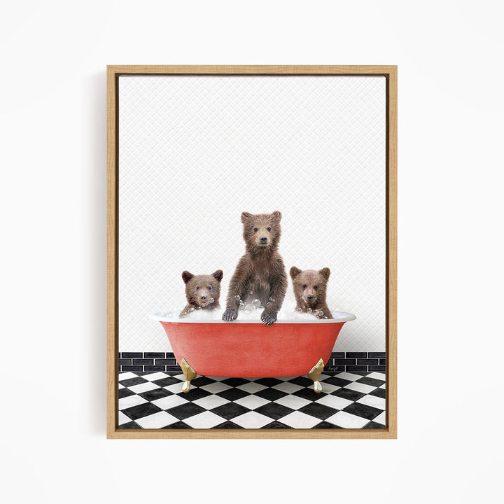 A framed image depicting three brown bears sitting in a red bathtub on a black and white checkered floor.