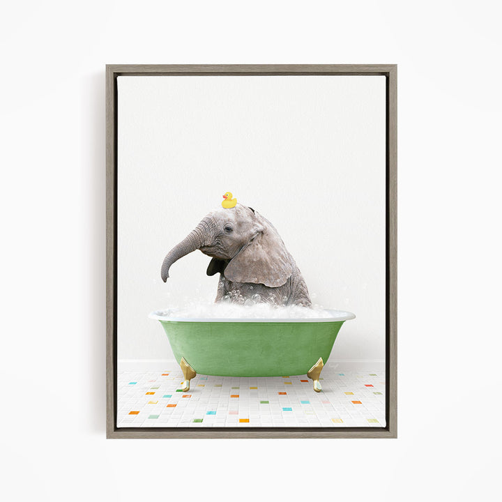 A gray elephant is sitting in a green bathtub, with a yellow rubber duck perched on its head.