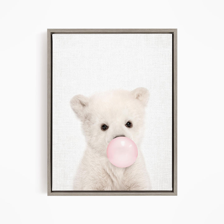 A cute white polar bear is blowing a bubble with a pink bubble gum bubble.