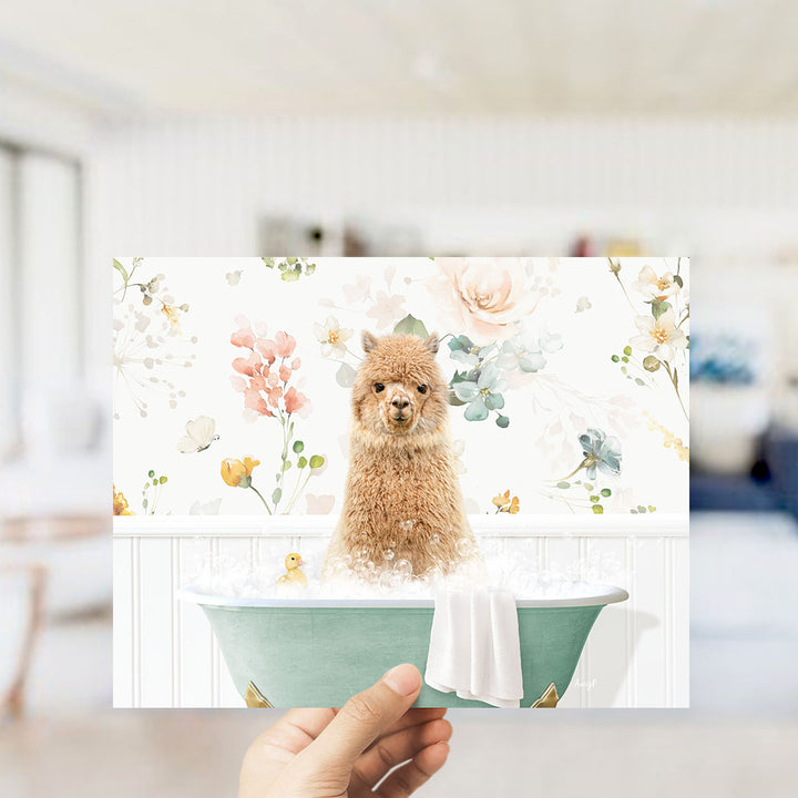 A hand holding a framed print featuring a small brown dog sitting in a bathtub filled with water and surrounded by flowers.