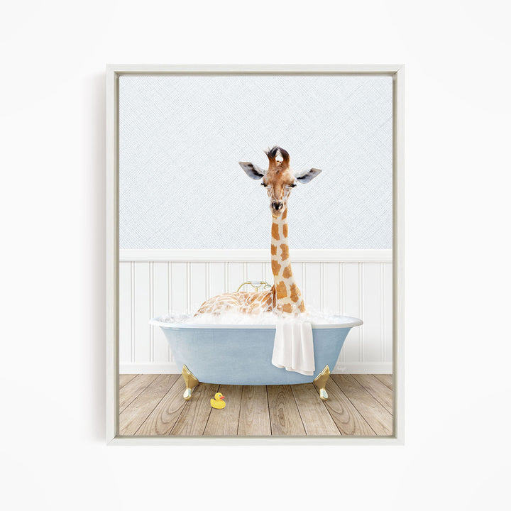 A giraffe is sitting in a blue bathtub filled with water, surrounded by a white wall and wooden floor.