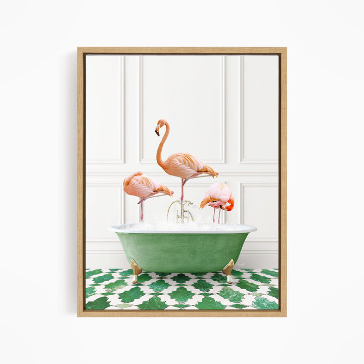 A framed image depicting three pink flamingos standing in a green bathtub filled with water, with a green and white patterned floor beneath.