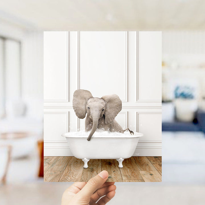 A small elephant sitting in a white bathtub filled with water, with its trunk submerged in the water.