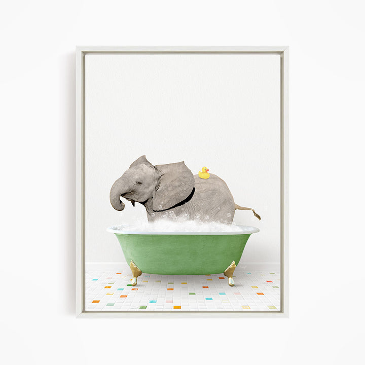 A gray elephant is sitting in a green bathtub filled with water, with a yellow rubber duck floating on its back.
