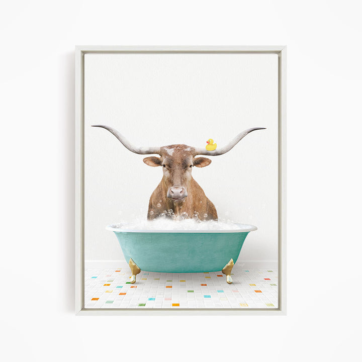 A brown cow with long horns is sitting in a green bathtub filled with bubbles, with a yellow rubber duck floating on the water.