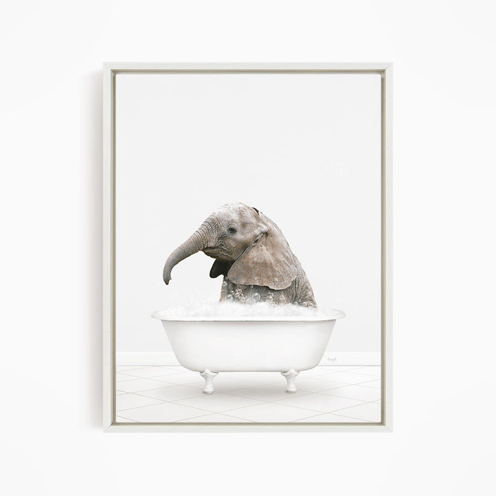 A baby elephant sitting in a white bathtub filled with water, appearing to enjoy the bath.