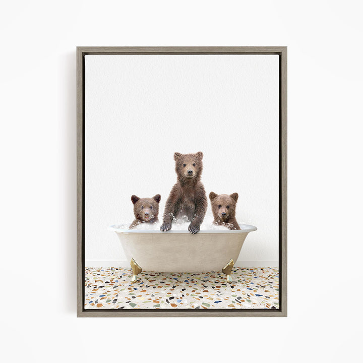 A framed image depicting three brown bears sitting in a white bathtub, with one bear sitting in the center and the other two bears sitting on either side.