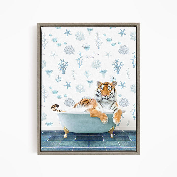A tiger is sitting in a bathtub filled with water, surrounded by a blue and white patterned wallpaper with various marine life and plants.
