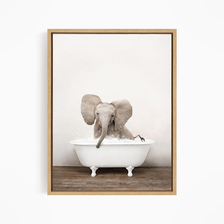 A baby elephant sitting in a white bathtub filled with water, with its trunk submerged in the water.